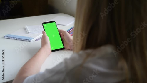 A woman touches a smartphone, selects creative ideas on the Internet