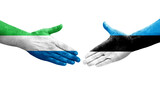 Handshake between Estonia and Sierra Leone flags painted on hands, isolated transparent image.
