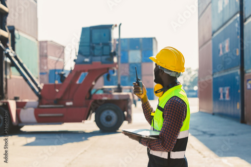 customs shipping staff worker working at cargo port container ship yard with radio control