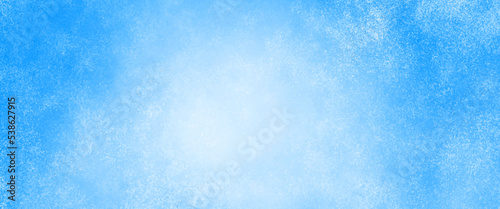 Blue background with faint texture and bright center and black vignette border, white cloudy center and abstract watercolor sky design texture, elegant sapphire blue background.