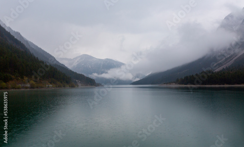 View from Top to the Austrian Plansee lake and its turquoise water and the deep green woods as a pure nature vacation spot photo