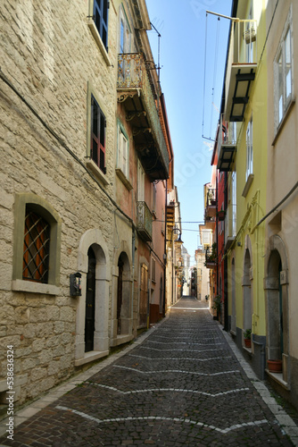 A narrow street between the old stone houses of Frosolone, a medieval village in the Molise region of Italy. © Giambattista