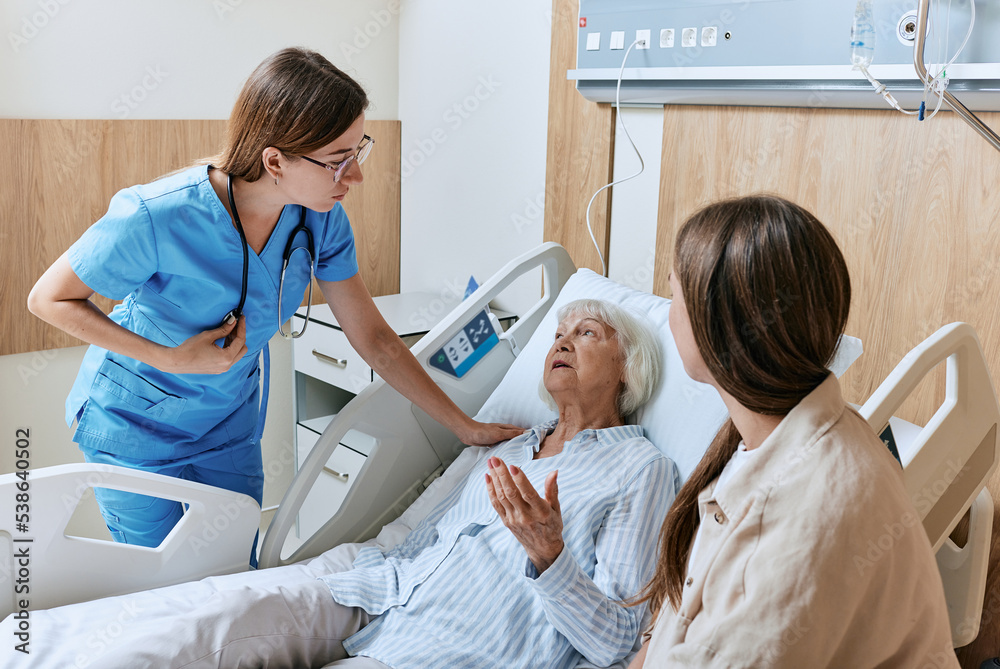 Ταπετσαρία Nurse caring for elderly patient lying in bed of hospital ward, elder care