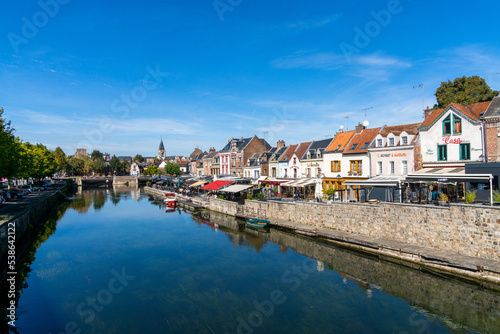 the canals of the Somme River and the historic old city center of Amiens under a blue sky