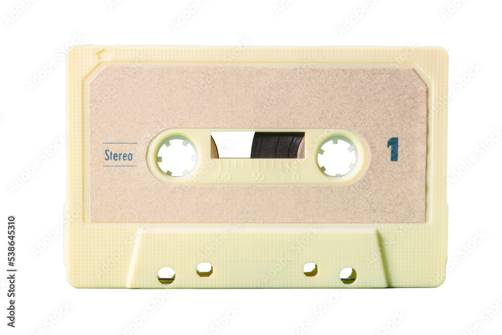 Fototapeta premium Isolated old vintage cassette tape from the 1980s (obsolete music technology). White cream plastic body, sand tone label. 
