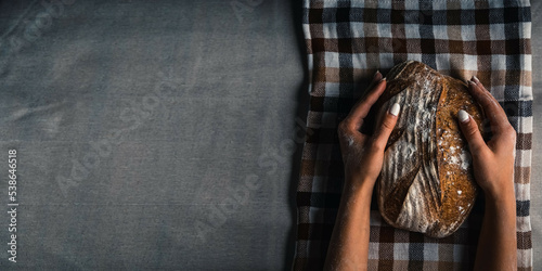 Photo of flour and female hands with flour splash. Cooking bread. Kneading the Dough. Isolated on dark background. Empty space for text.