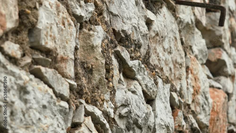 Old rock wall texture with natural aged rough stones close up Old rock wall texture with natural aged rough stones close up