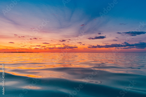 Beautiful sunset ocean water surface. Tranquil summer meditation relaxing seascape. Exotic sunrise beach sun rays  sea and horizon. Amazing nature view  waves colorful sky. Majestic beach coast shore 