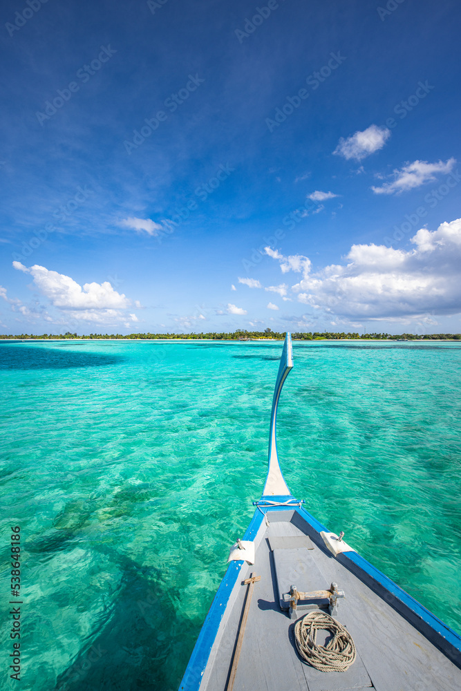 Wooden sailing boat in crystal clear tropical lagoon bay close to beach of deserted exotic island. Maldives Dhoni boat, vertical panorama as luxury travel landscape, amazing vacation wallpaper concept