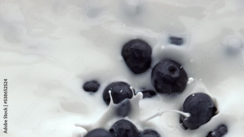 Closeup berries filling milk liquid. Berries floating inside calcium cocktail