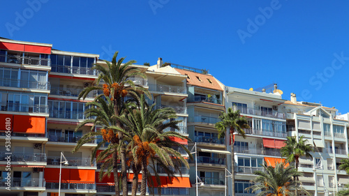 Street resort town in Spain, beautiful houses, bright balconies, a palm tree with orange fruits. Beautiful landscape, travel advertisement, Altea, Alicante