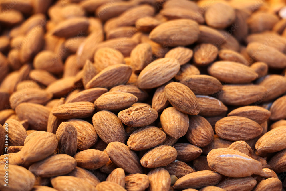 fresh peeled raw almonds ready for sale on counter, background fresh peeled raw almonds ready for sale on counter, background