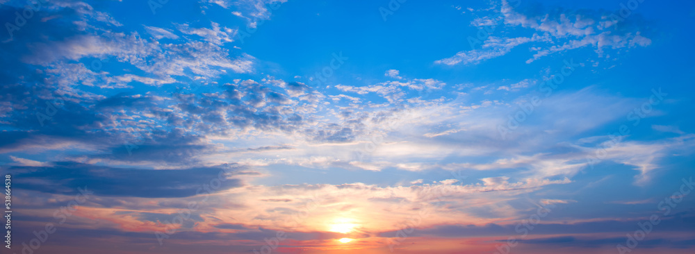 Beautiful sky with bright sunrise and light clouds. Wide format. Beautiful sky with bright sunrise and light clouds. Wide format.