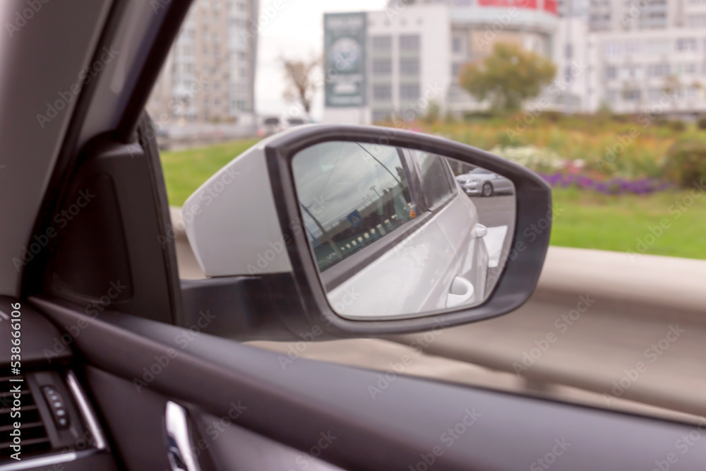 Side rear view mirror of the moving car. Toning