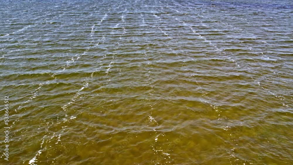 Aerial view of textured ripples lake at bay during windy day. Aerial view of textured ripples lake at bay during windy day.