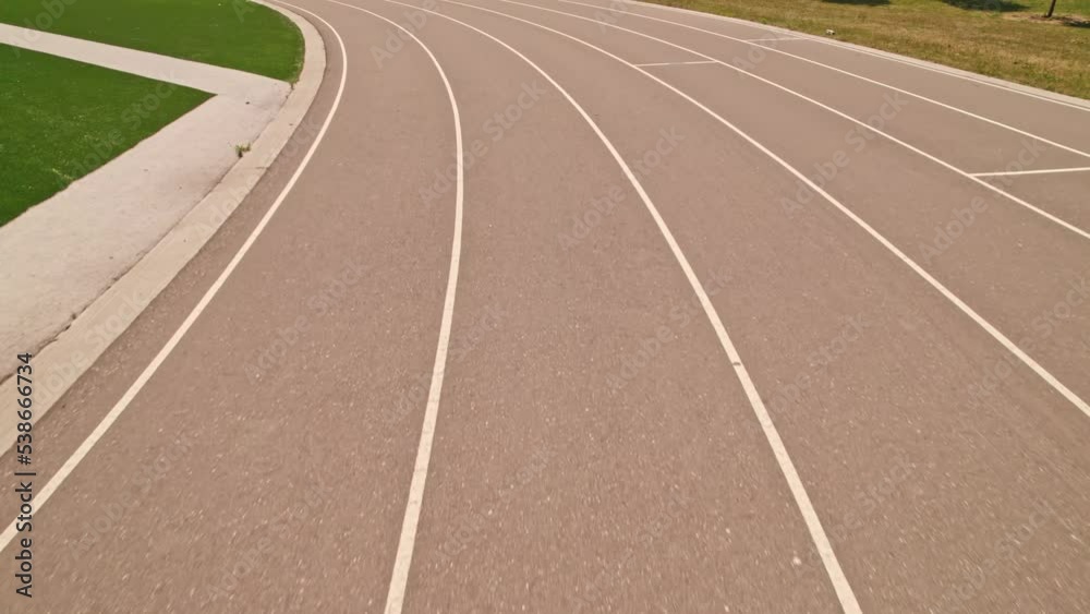 Running track for sport race POV sportsman view. Athletes point of view while training at running track. Aerial view of competing in the race. Running track for sport race POV sportsman view. Athletes point of view while training at running track. Aerial view of competing in the race.