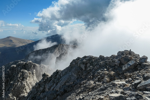 Panoramic view from cloud covered mountain summit of Mytikas Mount Olympus, Mt Olympus National Park, Macedonia, Greece, Europe. Home of the Ancient Greek gods. Hiking trail from Skala and Stefani © Chris