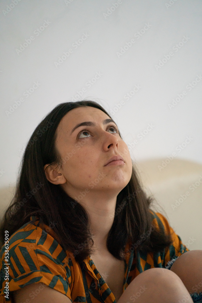 sad woman sitting on the couch sad woman sitting on the couch