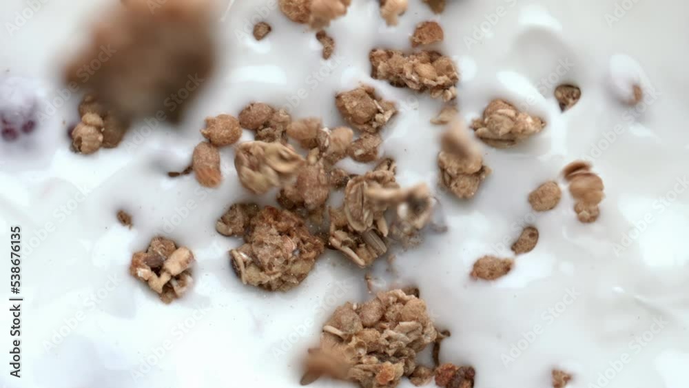 Yogurt granola dessert breakfast closeup. Tasty muesli falling creamy liquid Yogurt granola dessert breakfast closeup. Tasty muesli falling creamy liquid