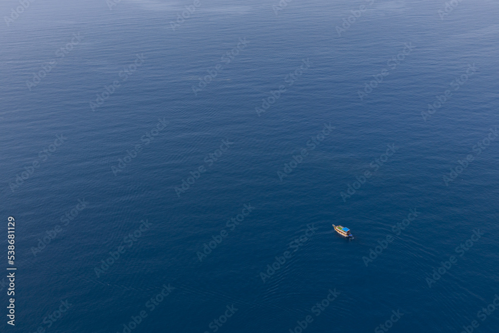 White boat on the surface of the blue sea. top view.ripples on the water.place for your text. High quality photo