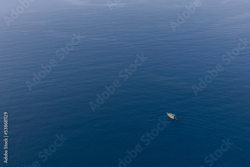 White boat on the surface of the blue sea. top view.ripples on the water.place for your text. High quality photo