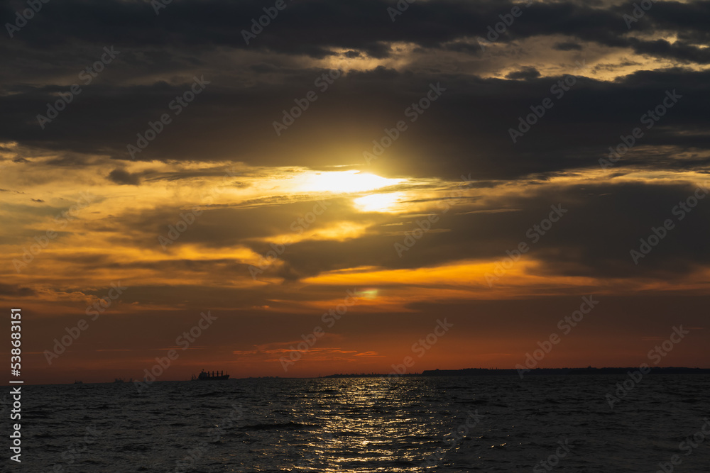 Fototapeta premium Amazing Black sea sunset, Nature landscape background. Drama sky ,sun and clouds. Blue hour at the ocean romantic evening. Ship on the horizon. Tropical island summer paradise. Night sky meditation