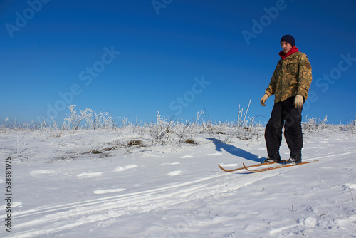 military in winter,Ukrainian military man descends from the mountain on skis