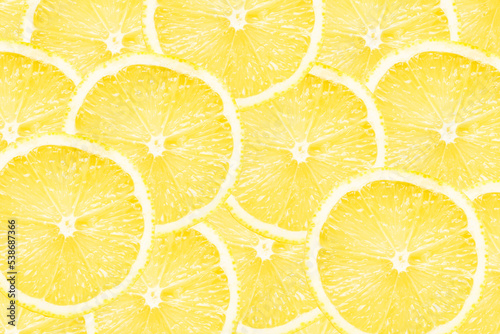 Yellow lemon slices background. Fruit pattern. Cut slices color texture. Lemon fruit section backdrop.