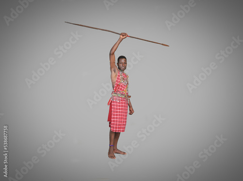 Masai warrior moran carrying spear over his head.African safari concept.War chants.Empty blank grey mockup background