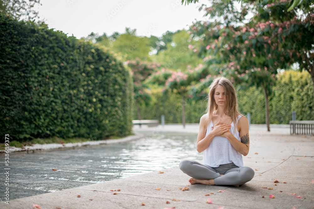 Girl practice yoga meditation outdoor in park Girl practice yoga meditation outdoor in park