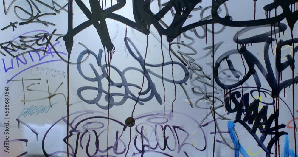 Close-up picture vandalism on glass in the city. Street hooligans painted, damaging property. Post signs and symbols on walls and windows. Camera movement, shaking. CZ, Prague, Republici, 30.9.22 Close-up picture vandalism on glass in the city. Street hooligans painted, damaging property. Post signs and symbols on walls and windows. Camera movement, shaking. CZ, Prague, Republici, 30.9.22