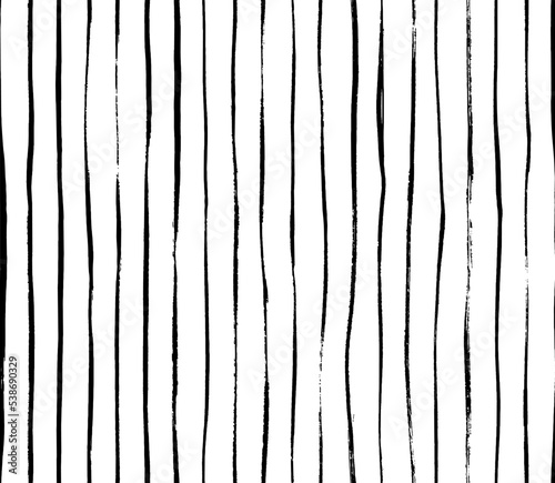 Brush drawn thin vertical lines seamless pattern. Decorative ornament with handdrawn lines. Grungy ink doodles with stripes. Black and white geometric pattern. Vertical parallel straight brush strokes
