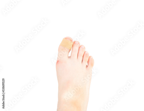 foot with medical patch plaster on the finger isolated on white background