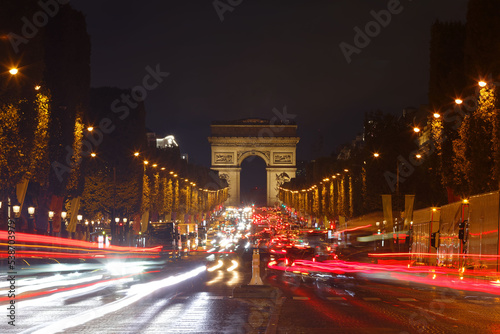 The Triumphal Arch and Champs-Elysees avenue in rainy evening, Paris, France. © kovalenkovpetr
