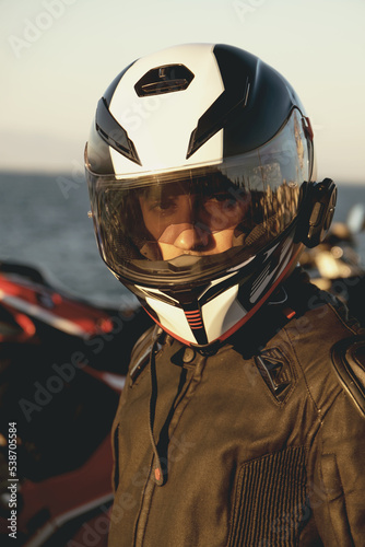 Portrait of a motorcycle rider with helmet.