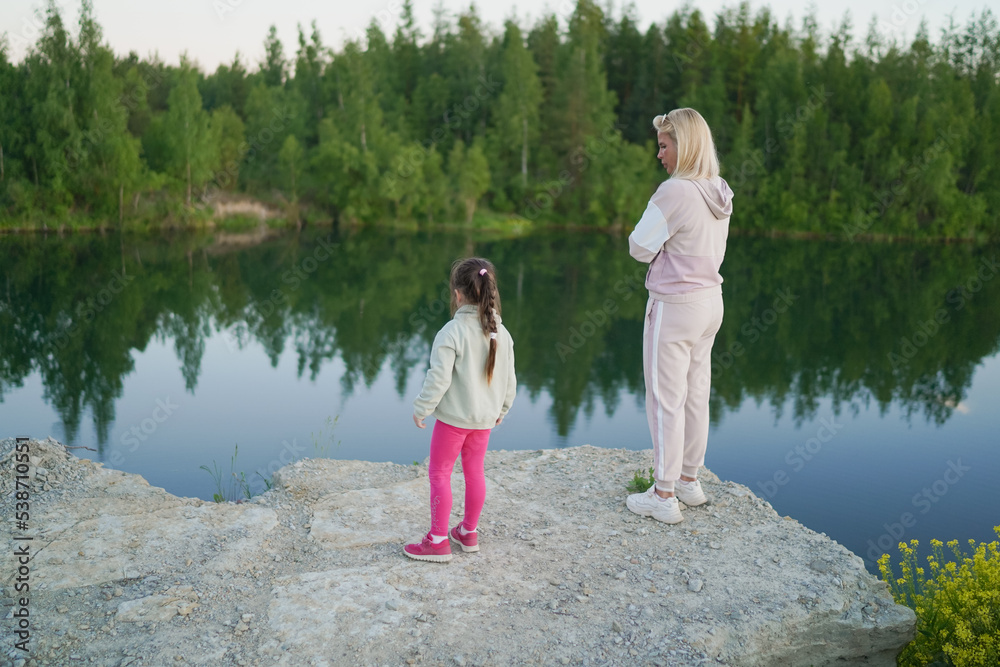 Mom and daughter outdoors in the evening.