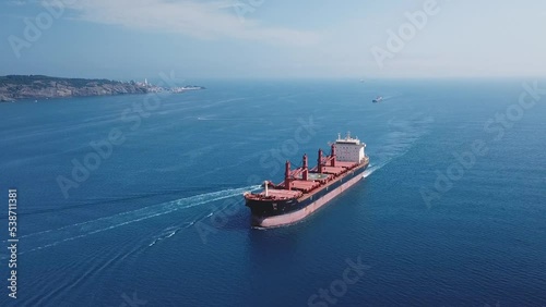 A cargo ship sailing northbound on Straits Bosporus. Aerial. Bulk carrier or bulker is a merchant ship specially designed to transport unpackaged bulk cargo, such as grains, ore, coal or timber

