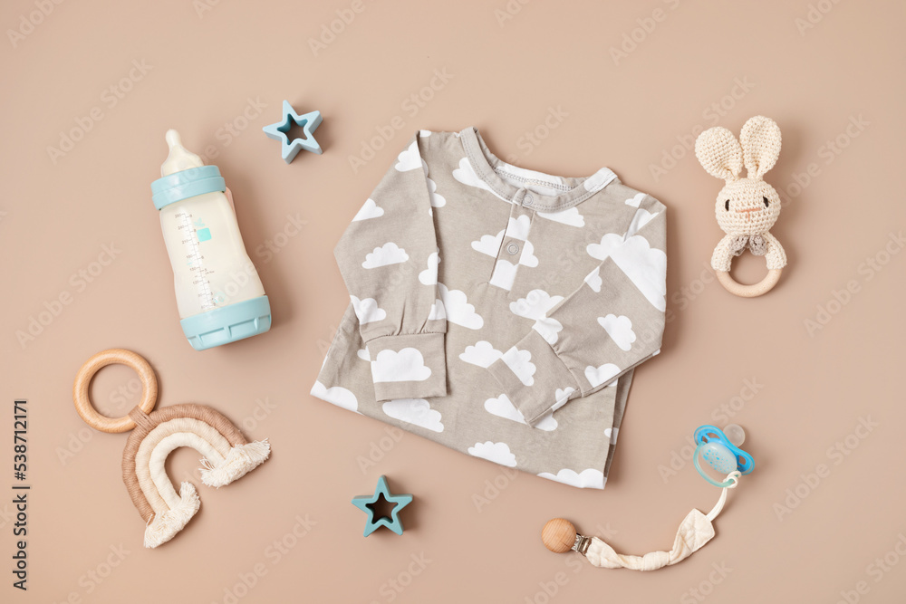 Flat lay with baby sleep accessories with milk bottles, pacifier, pajamas and toys. Newborn sleeping rules concept