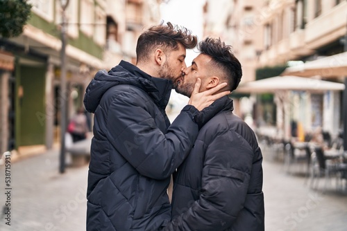 Young couple standing together kissing at street © Krakenimages.com