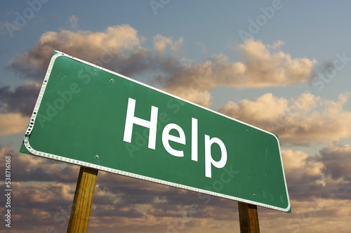 Help Green Road Sign Under Golden Cloudy Skies