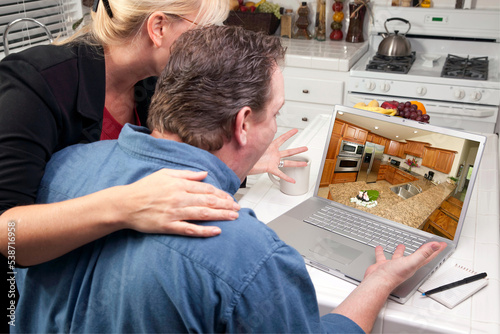Couple In Kitchen Looking a...