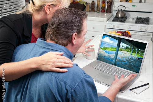 Couple In Kitchen Looking at a Vacation Rental on Their Laptop  © Andy Dean