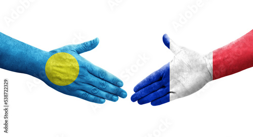 Handshake between France and Palau flags painted on hands, isolated transparent image.