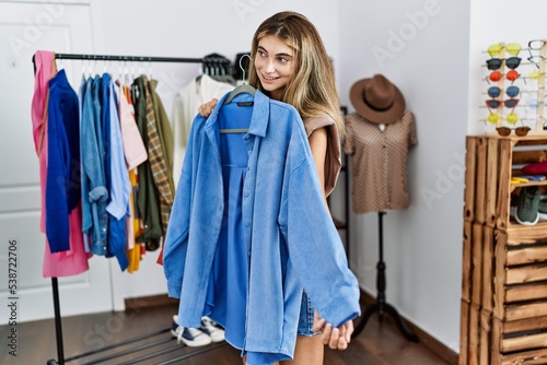 Young caucasian woman smiling confident shopping at clothing store