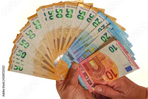 woman's hands holding fan-shaped euro banknotes