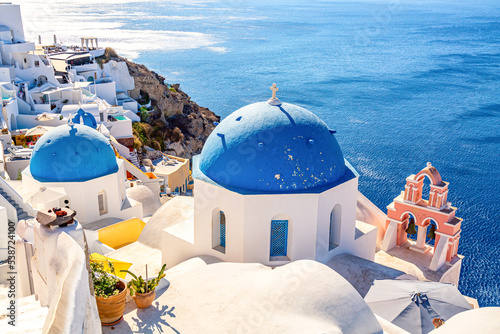 Famous Santorini iconic view. Blue domes and traditional white houses. Oia village, Santorini island, Greece.