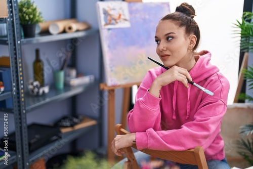 Young woman artist smiling confident drawing at art studio