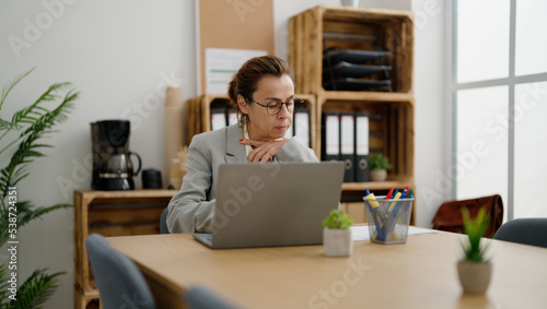 Middle age hispanic woman business worker working at office
