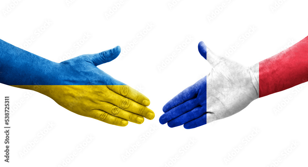 Handshake between France and Ukraine flags painted on hands, isolated transparent image. Handshake between France and Ukraine flags painted on hands, isolated transparent image.