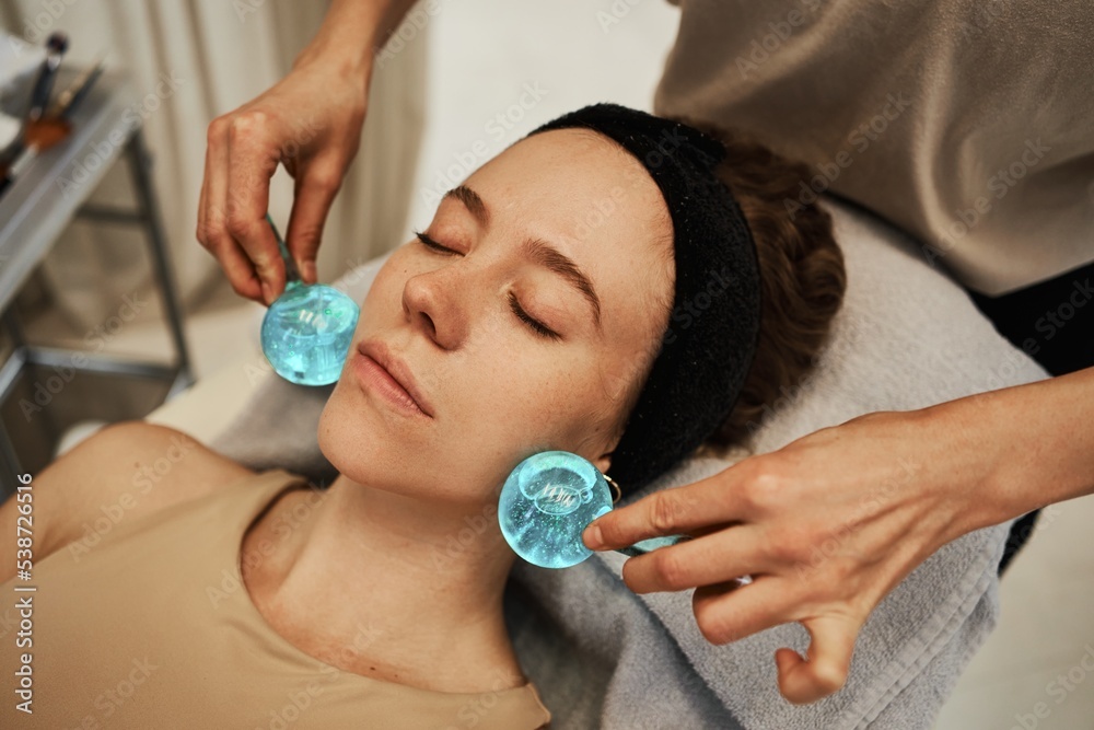 Facial massage with cold spheres. Facial massage with cold spheres.